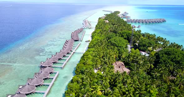 Wide above clean view of a paradise sunny white sand beach and blue water background