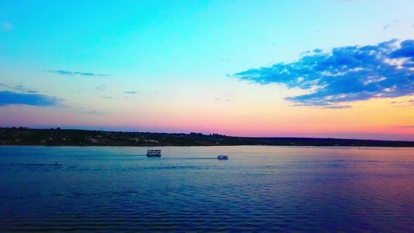 Slow aerial drone shot flying over Lake Paranoa at dusk