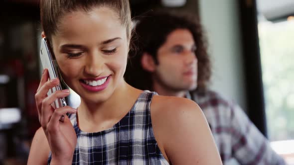 Smiling woman talking on mobile phone