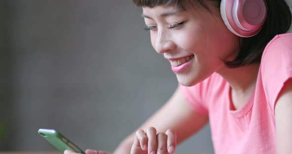 Woman enjoy music on headphone at home