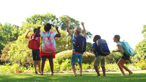 Group of kids jumping together in park