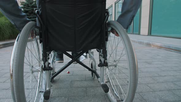 A Man Rides in a Wheelchair