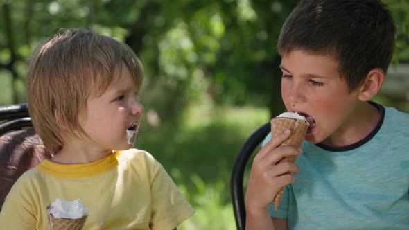 Cute Boys Enjoy Eating a Cool Dessert with Ice Cream While Relaxing on a Hot Summer Day