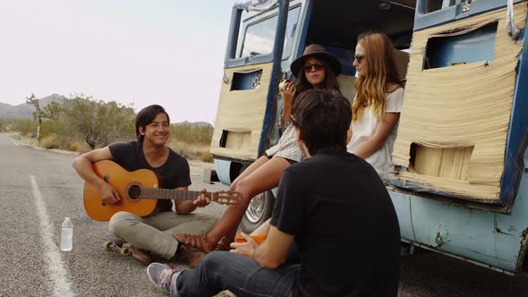 Group of young people sitting together on van