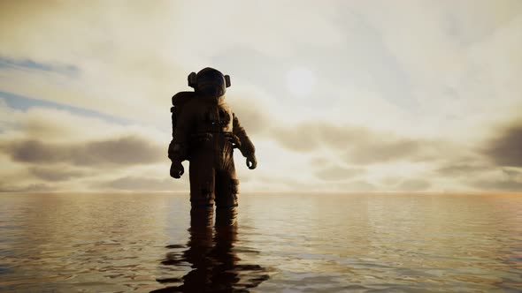 Spaceman in the Sea Under Clouds at Sunset