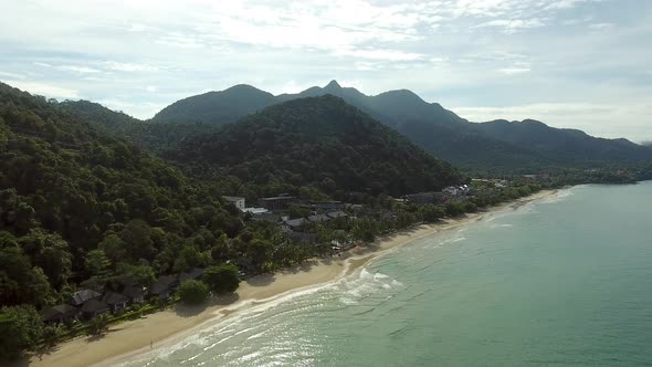 Aerial view of small coastal city surrounding by tropical forest, Thailand.