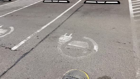 Many Electric Car Charging Signs at Mall Parking Lot