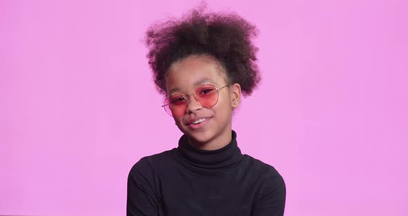 Portrait of a Beautiful African Girl on a Pink Background Girl Video Blogger Talking Laughs and
