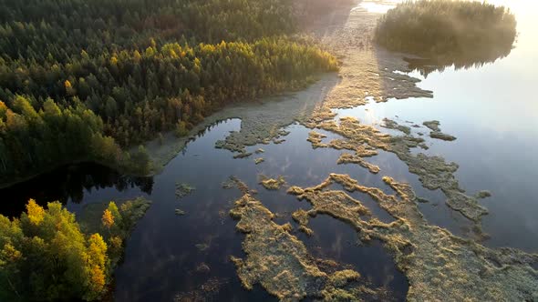 Aerial Shot of Foggy Lake with Islands Early in the Morning. Finland, Near Rovaniemi