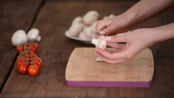 Woman Is Peeling Off Mushroom on Kitchen