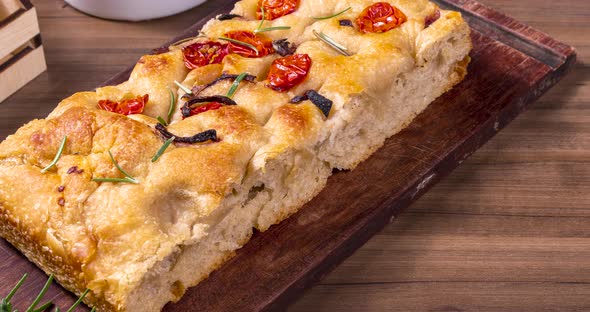 Traditional Italian Focaccia with pepperoni, cherry tomatoes, black olives, rosemary ando onion - ho