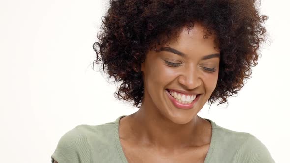 Young Beautiful African Girl Laughing Over White Background