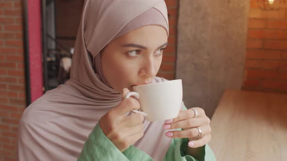 Muslim Woman Drinking Coffee