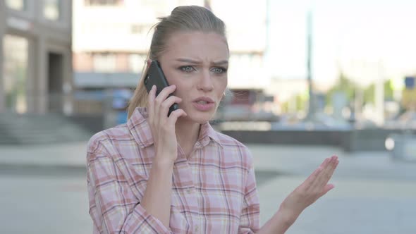 Angry Young Woman Talking on Phone Outdoor