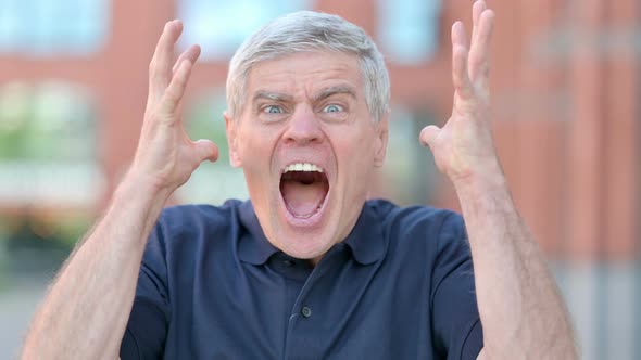 Outdoor Portrait of Angry Middle Aged Man Screaming Loud