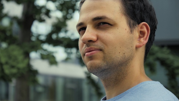 Handsome man portrait. Office buildings background