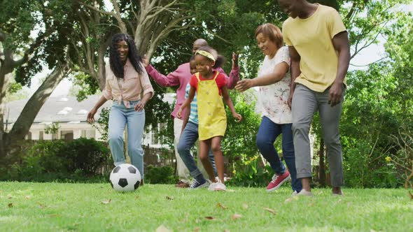 Animation of happy african american family playing football in garden