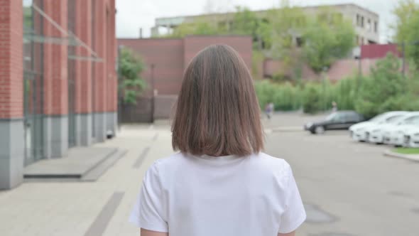 Close up of Young Woman Walking on Street, Back View