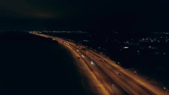 Aerial view of winter night highway with orange lanterns 01