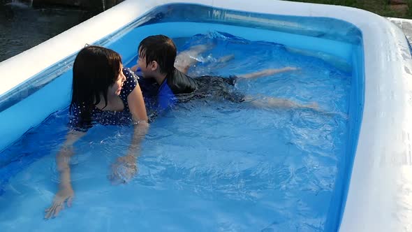 Cute Asian Children Swimming And Playing In A Pool Slow Motion