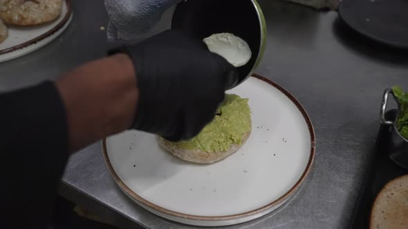 Avocado Egg Sandwich with Whole Grain Bread Served on Plate, Chef Hands