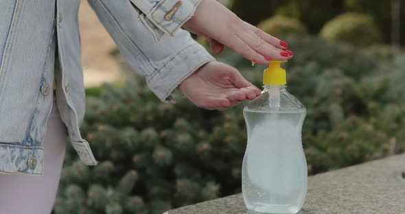 Close View of Female Hands Disinfectants Hand with Sanitizer Outdoors