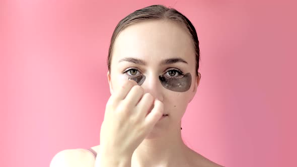 Head shot portrait close up smiling young woman with under eye moisturizing patches mask