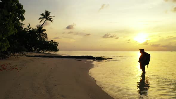 Girl tanning on tranquil bay beach journey by turquoise sea and white sandy background of the Maldiv