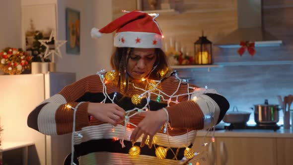 Young Adult with Knotted String of Christmas Lights