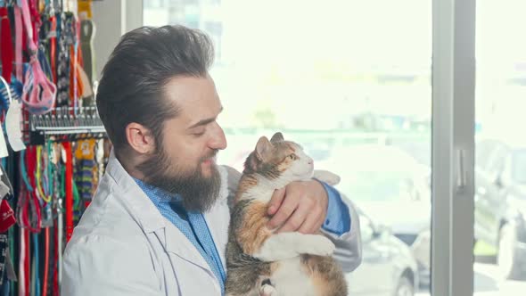 Friendly Vet Smiling To the Camera Holding Cute Grumpy Cat alt