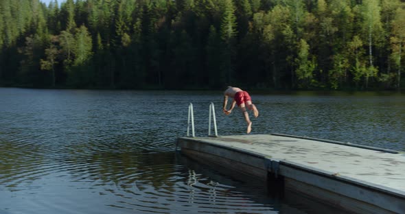 Man Run on Dock To Jump in Cold Mountain Lake