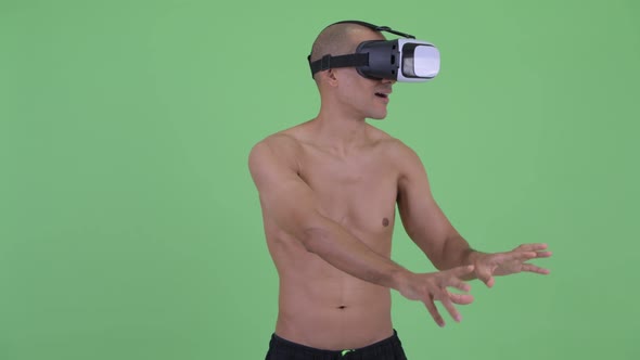 Happy Bald Multi Ethnic Shirtless Man Using Virtual Reality Headset