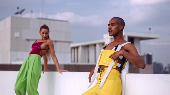 Dancers Performing And Singing In Clubwear On City Rooftop