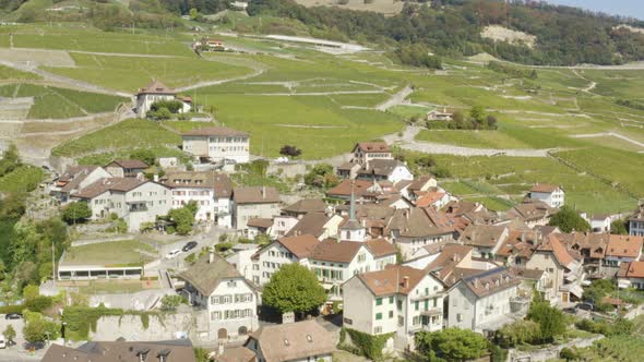 Aerial orbit around typical village (Riex) in Lavaux vineyard - Switzerland