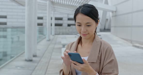 Young woman use of mobile phone in city