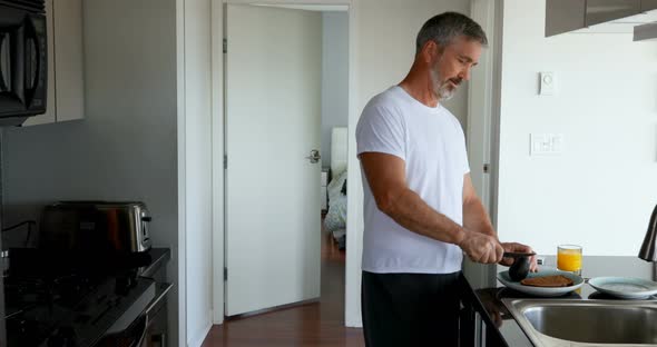 Man preparing breakfast in kitchen