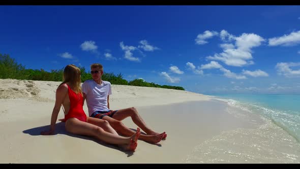 Guy and girl sunbathe on tropical resort beach time by clear ocean and white sand background of the 