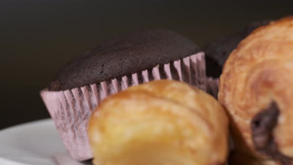 Various types of cakes on white plate rotating in front of camera, Close-up rotates view of Sweets