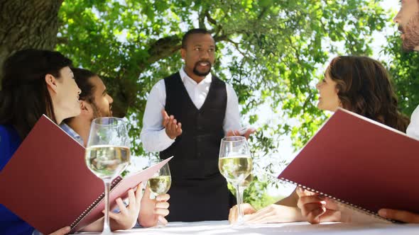 Waiter taking an order from couples