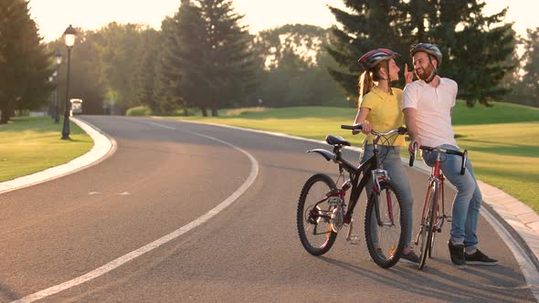 Couple of Young Cyclists Kissing on the Road