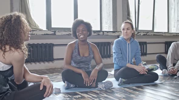 Young Women Chatting in Yoga Class