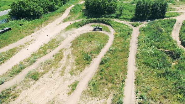 Top View of a Terrain Track with a Racing Car Driving Through