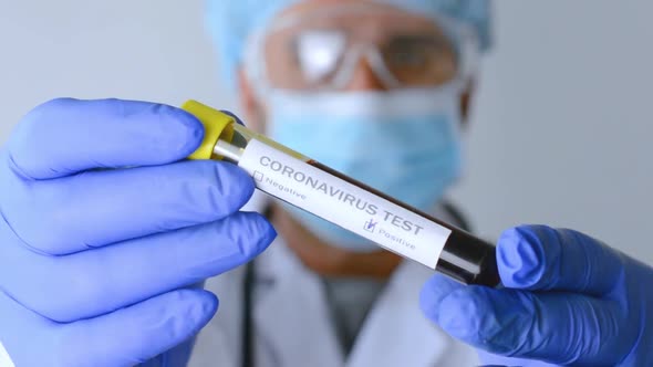 Doctor holds a test tube with blood for coronavirus test