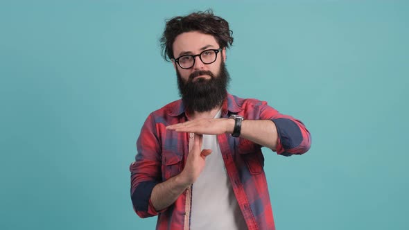 Portrait of a Bearded Man Making the Time Out Gesture, Asking for a Break