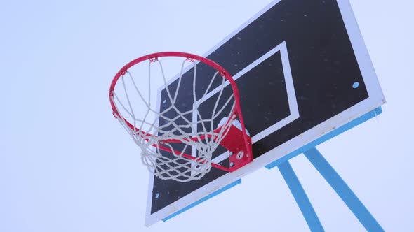 Basketball Ball Flies Into the Basket in the Winter.