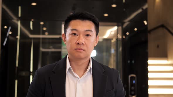 Portrait of Adult Asian Businessman in Formal Suit Looking to Camera Confident