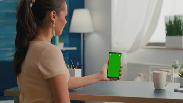 Social Media Woman Holding Touchscreen Phone with Mock Up Green Screen