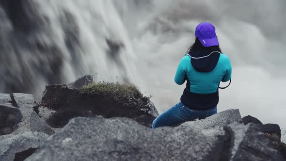 Female Photographer Taking Pictures of Powerful Waterfalls in Iceland