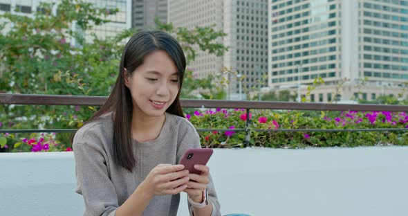 Woman check on smart phone in city