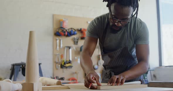 Carpenter marking with pencil on wood 4k